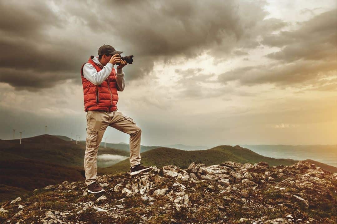 photographer posing in a valley during bad weather