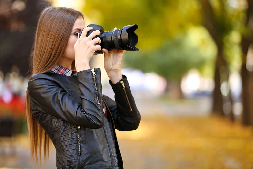 model using a camera to shoot a portait photography