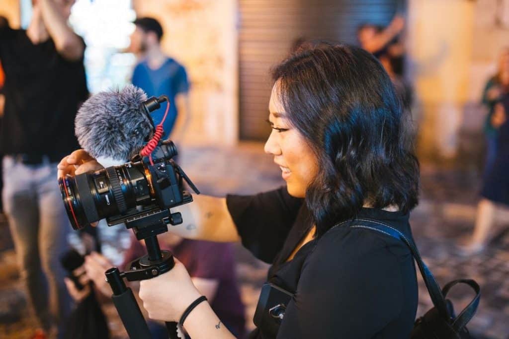 woman shooting a video for a vlog with a canon camera