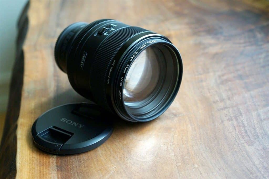 Sony FE 85mm F1.4 GM lens on a wooden table