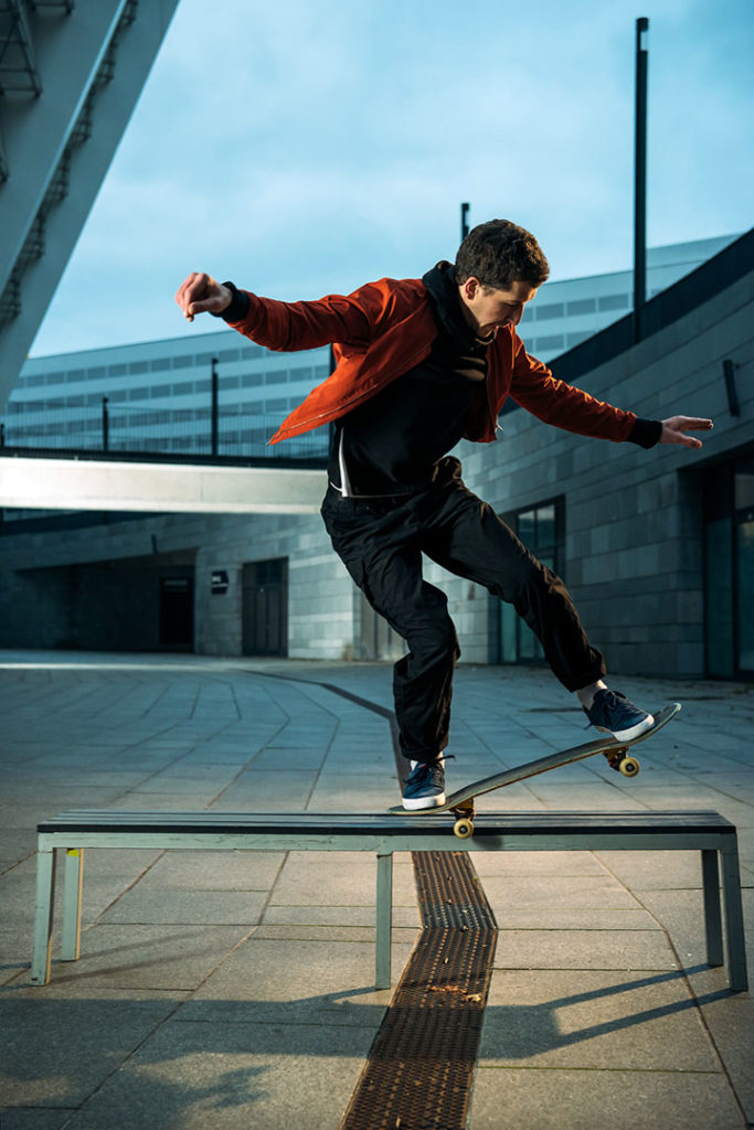 skateboarder performing tricks in low light